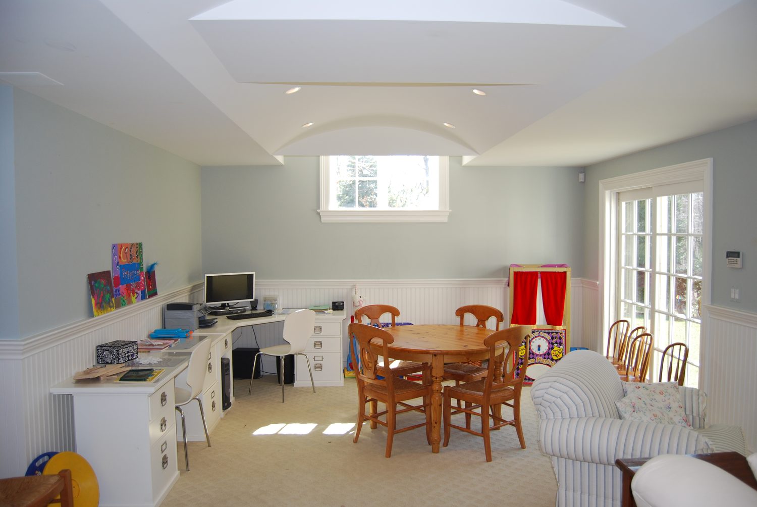 Barrel-vaulted playroom with a built-in desk run