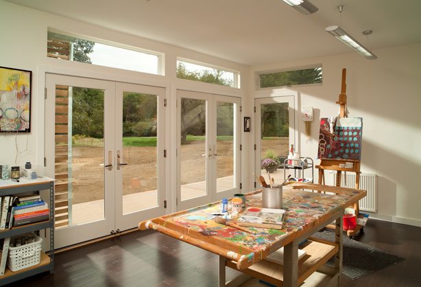 Artist's studio interior with full-height glazed doors