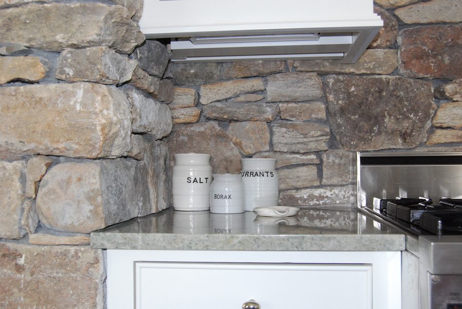 The kitchen, built around the stone chimney breast