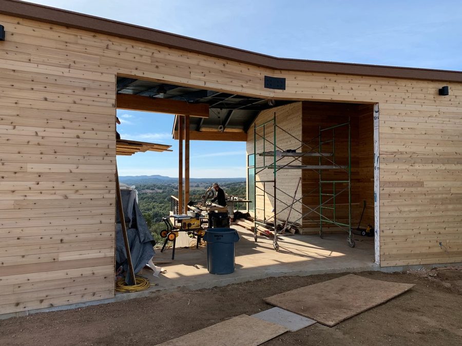 Curved cedar-clad breezeway through the building
