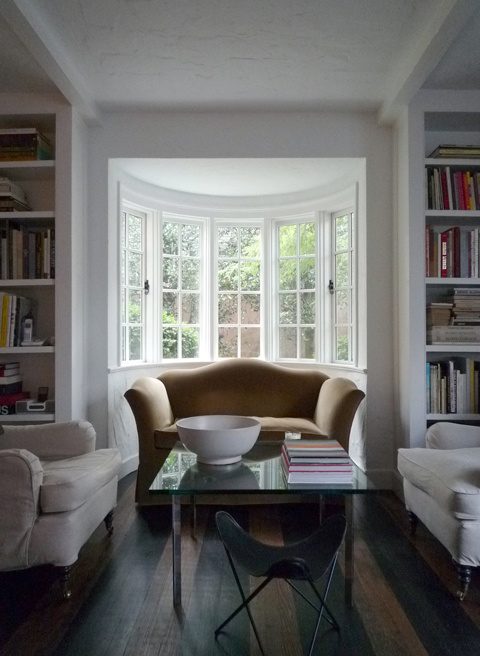 Bay window sitting room with built-in bookcases