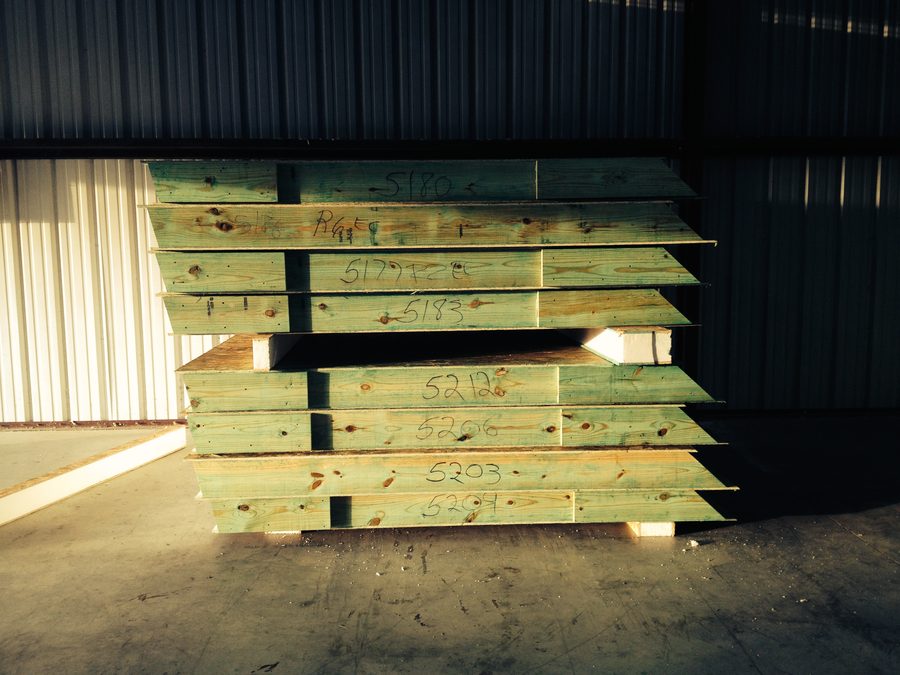 Finished panels racked and numbered in the shop, ready to ship
