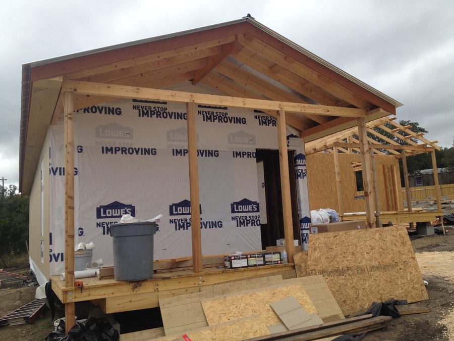 A cabin near completion with its porch framed