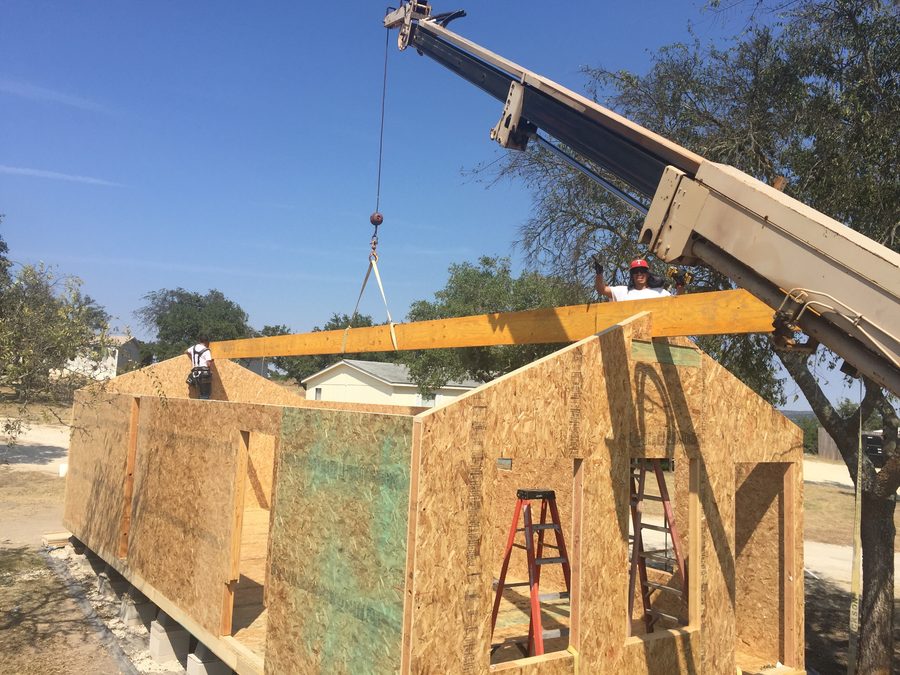Ridge beam craned in above the standing wall panels